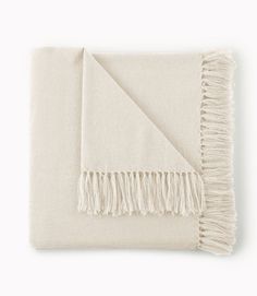 a white blanket with fringes on it