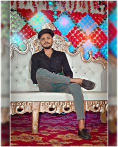 a man sitting on top of a white bench in front of a colorful wall and floor