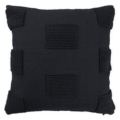 a black pillow with pleated details on it