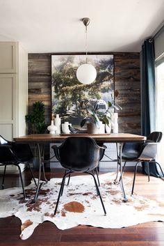 an image of a table with chairs and pictures on the wall above it that are for sale