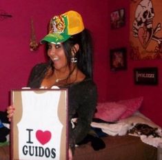 a woman holding up a sign that says i love gudos in front of her