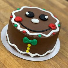 a decorated chocolate cake sitting on top of a wooden table