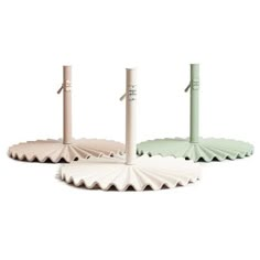 three white and green umbrellas sitting on top of each other