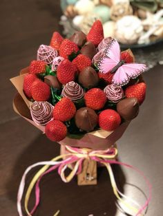 a bouquet of strawberries and chocolates on a table