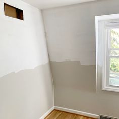 an empty room with white walls and wood floors in the foreground is being painted