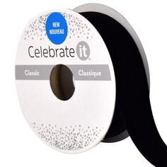 a spool of black ribbon with white dots on the side and an inscription celebrating it