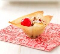 a piece of food that is on top of a red place mat in front of a white table