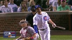 a baseball player holding a bat next to home plate in front of an audience at a game