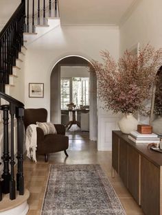 a living room filled with furniture and a large rug