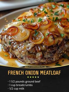 a close up of a plate of food with meat and onions on it, next to a fork