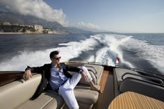 a man sitting on the back of a boat