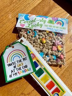 a box of cereal sitting on top of a wooden table next to a candy bar