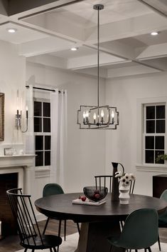 a dining room table with four chairs around it