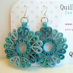 the earrings are made out of paper and have circular designs on them, as well as beads