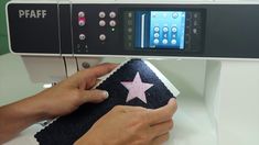 someone is using a sewing machine to sew a star on a piece of fabric