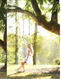 a woman in white dress sitting on a swing