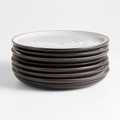 black and white plates stacked on top of each other