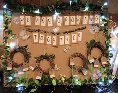 a bulletin board decorated with wreaths, lights and words that spell out we are growing together