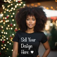 a woman wearing a black t - shirt with the words sell your design here on it