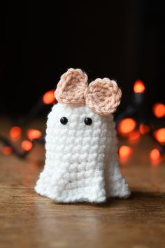 a white crocheted object with two ears on it's head and eyes