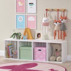 a child's playroom with toys and pictures on the wall