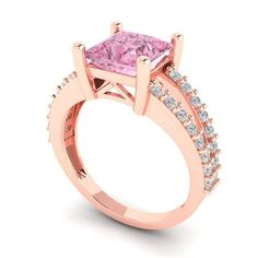 a pink diamond ring with two rows of diamonds on the band and side stones around it