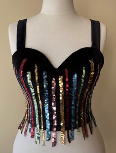 This Black Velvet corset, which we named Dancing Queen, was handcrafted individually in our workshops. Each model is worked on only one size and is personalized. The beads and materials on it were carefully selected and hand-sewn. Your cargo is carefully packed and sent to you. Size     : EU 36  / USA 4 / UK 8 / S Adjustable corset with back tie Dimensions are flexible 6 cm (2,5 in) Color   : Black Sequined Corset With Fitted Bodice For Parties, Sequined Fitted Corset For Party, Sleeveless Corset With Corset Back For Party, Sleeveless Boned Bodice Corset For Party Season, Sequin Corset With Sweetheart Neckline And Fitted Bodice, Sleeveless Party Corset With Corset Back, Sequin Corset With Sweetheart Neckline, Sequined Corset For Party Season, Glamorous Sequined Corset With Sweetheart Neckline