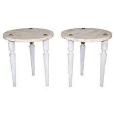 two white marble tables with wooden legs