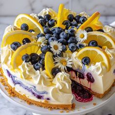 a cake with lemons, blueberries and orange slices