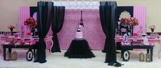 a room decorated in pink and black for a party