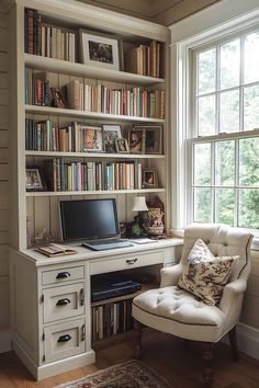 a white chair sitting in front of a book shelf filled with books