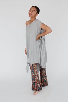 As a dress or tunic top, this cute and comfy piece has a trendy, slouchy silhouette. This closet favorite is a one-size piece that can be layered over tanks and bralettes, worn on or off-the-shoulder, and styled with a knot in the hem. One size fits all Fabric: 95% Rayon, 5% Spandex Hand wash cold, Lay flat to dry Made in Mexico Casual Tunic Top For Loungewear, Sleeveless Rayon Loungewear Dress, Sleeveless Rayon Dress For Loungewear, Bohemian Sleeveless Dress For Layering, Casual Flowy Rayon Tunic, Trendy Sleeveless Loungewear Dresses, Oversized Summer Dresses For Loungewear, Casual Stretch Tunic For Summer, Oversized Summer Loungewear Dress