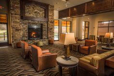 a living room filled with furniture and a fire place in the middle of it's walls