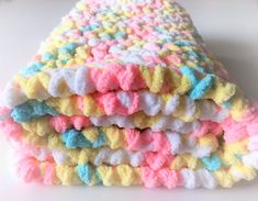 three crocheted blankets stacked on top of each other