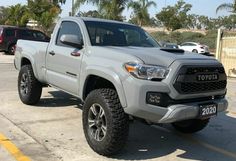 a silver toyota truck parked in a parking lot