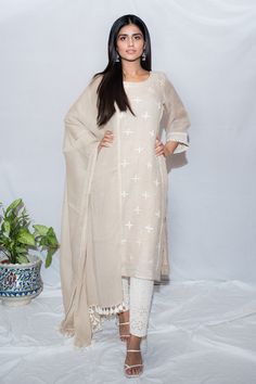 Beige cross embroidered kurta with lace work detail. Paired with schiffli pant and cotton dupatta.
Component: 3
Pattern: Embroidered
Type Of Work: Thread work
Neckline: Round
Sleeve Type: Three quarter
Fabric: Linen, Cotton
Color: Beige
Other Details: 
A line sleeves
Tassel dupatta
Occasion: Work - Aza Fashions Tassel Dupatta, Kurta Set For Women, Cotton Dupatta, Thread Work, Kurta Set, Linen Dresses, Set For Women, Aza Fashion, Sleeve Type