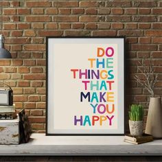 a framed poster with the words do the things that make you happy in multicolored letters