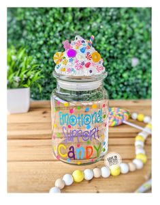 a jar filled with candies on top of a wooden table