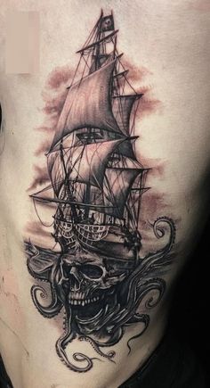 a man's chest with an octopus and ship tattoo on it