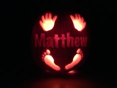 a carved pumpkin with hands and feet on it