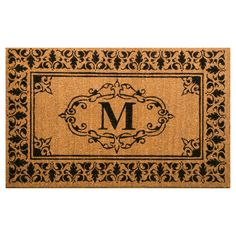 a door mat with the letter t on it and an ornate border in black ink