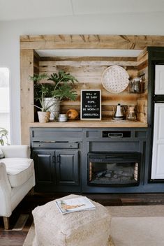 a living room filled with furniture and a fire place in the middle of it's wall