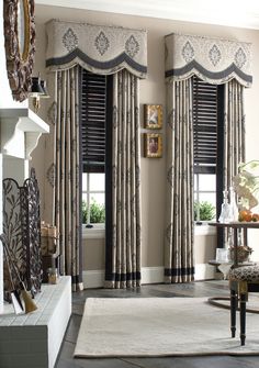 an elegant living room with black and white curtains