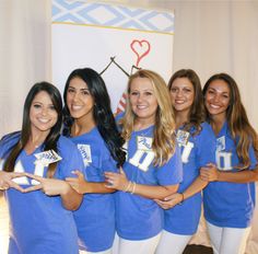 a group of young women standing next to each other