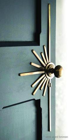 a door with a clock on the front and side of it that is painted teal