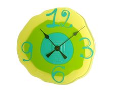 a green and yellow clock with numbers on the face, in front of a white background