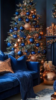 a living room decorated for christmas with blue and gold decorations