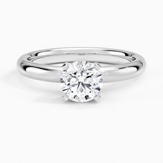 a white gold ring with a round cut diamond