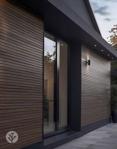 an exterior view of a modern home with wood siding