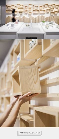 there are many shelves in the store that have wooden boxes on them and one is holding something